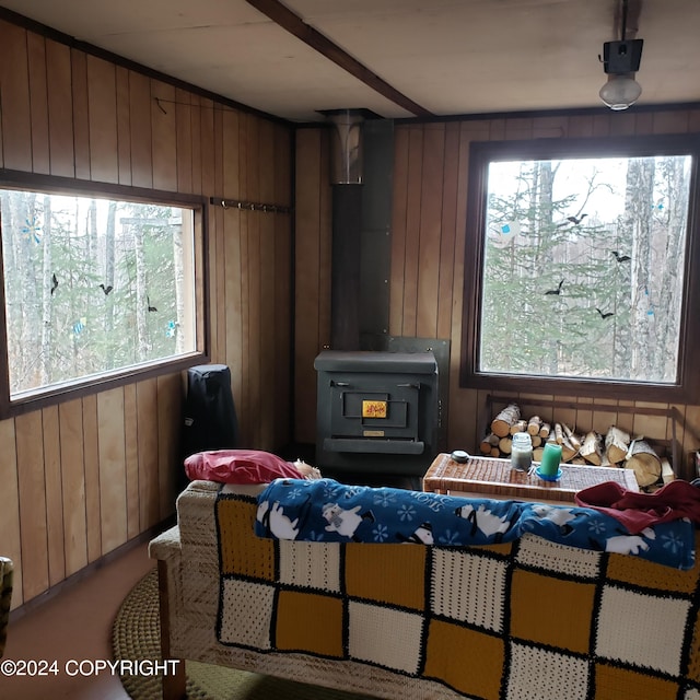 bedroom with multiple windows and wooden walls