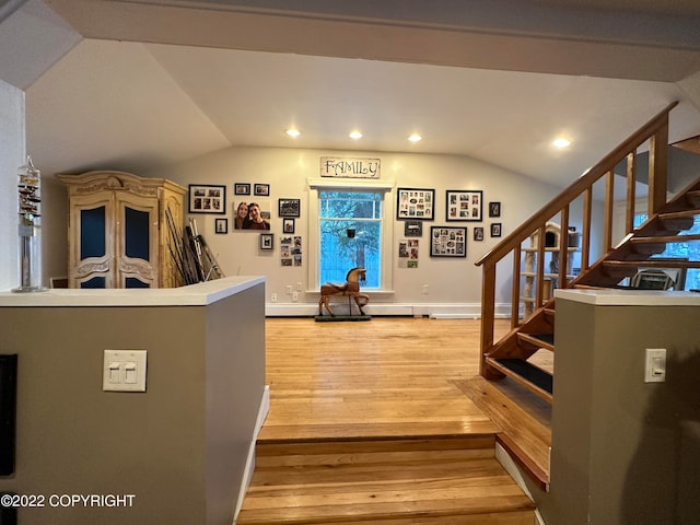 foyer entrance with lofted ceiling and hardwood / wood-style flooring