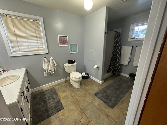 bathroom featuring toilet, vanity, and tile flooring