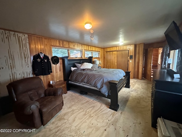 bedroom with wood walls