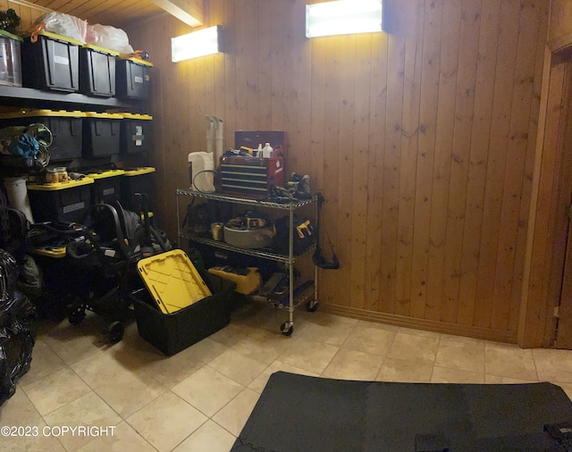 interior space with wooden walls and light tile flooring