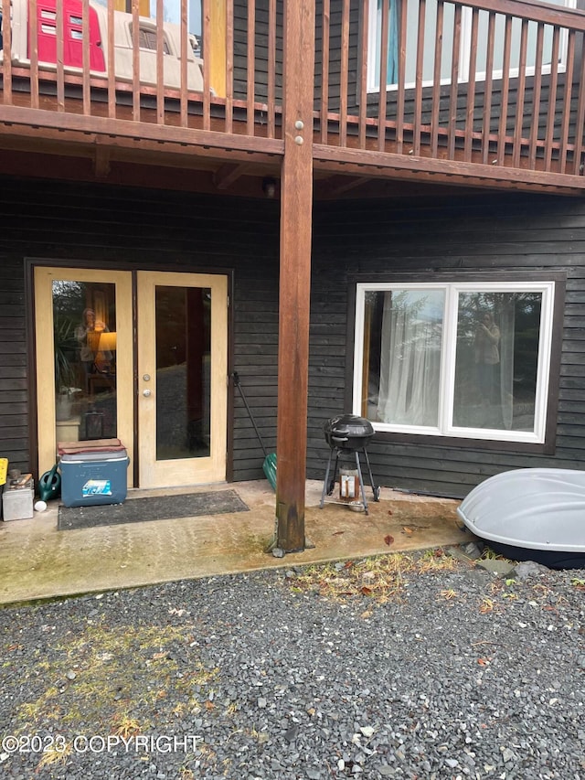 entrance to property with a patio and a wooden deck