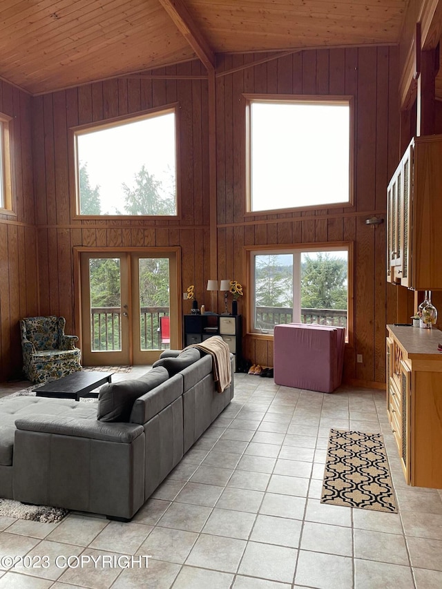 living room with high vaulted ceiling, wood walls, and wood ceiling