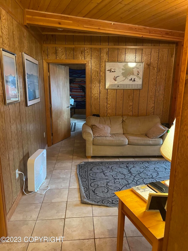 tiled living room featuring wooden walls, beam ceiling, and wood ceiling