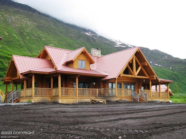 cabin featuring covered porch and a mountain view