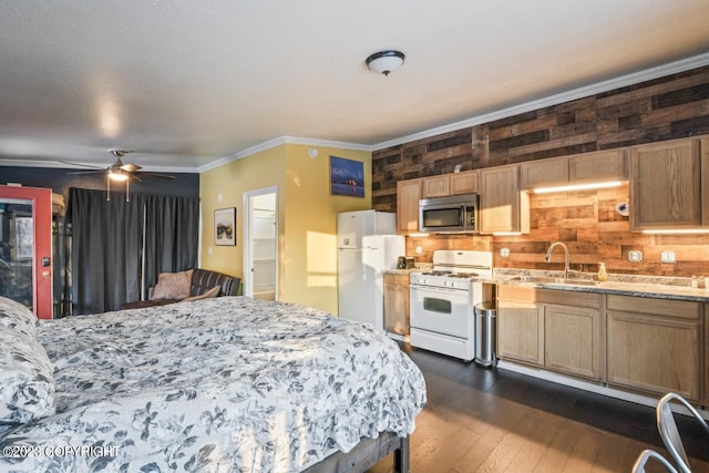 bedroom with ceiling fan, dark hardwood / wood-style flooring, sink, white refrigerator, and crown molding