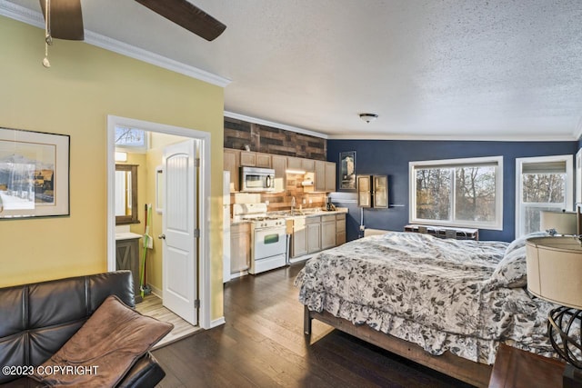 bedroom with dark hardwood / wood-style floors, ceiling fan, sink, vaulted ceiling, and a textured ceiling