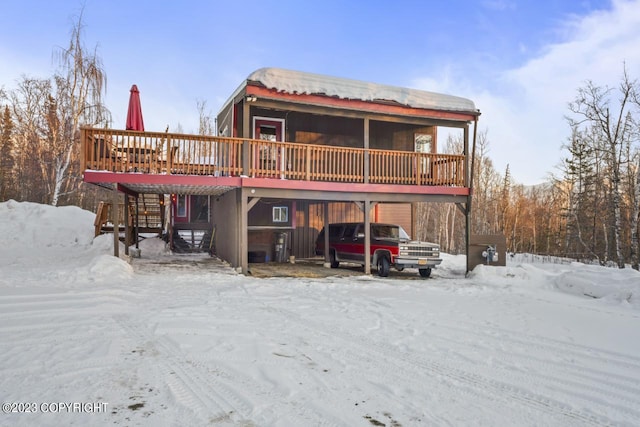 snow covered property featuring a deck