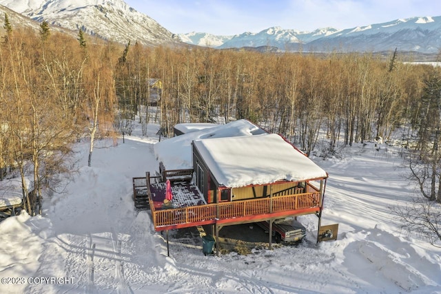 snowy aerial view featuring a mountain view