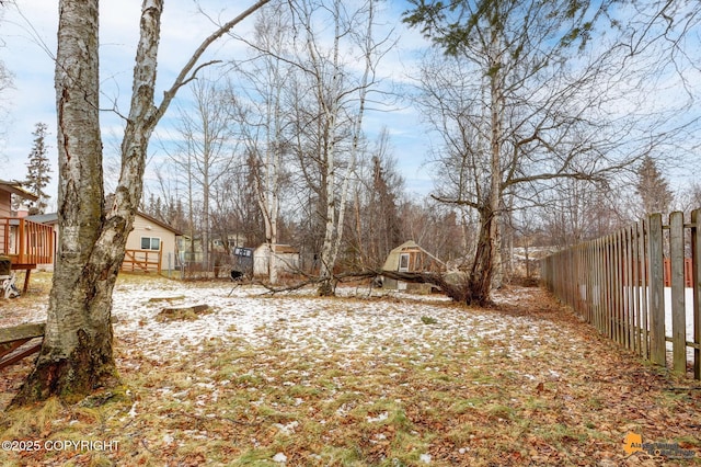 view of yard featuring fence and a wooden deck