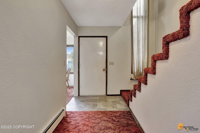 entryway featuring a textured ceiling, a textured wall, and light carpet