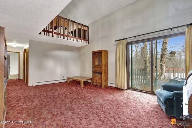 carpeted living room featuring a baseboard radiator, a textured ceiling, and a high ceiling