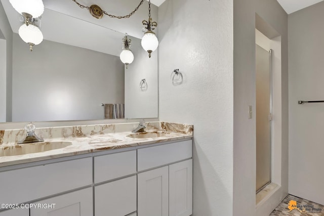 full bath with double vanity, a sink, and a shower stall