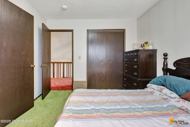 bedroom with multiple closets, light carpet, and a textured ceiling