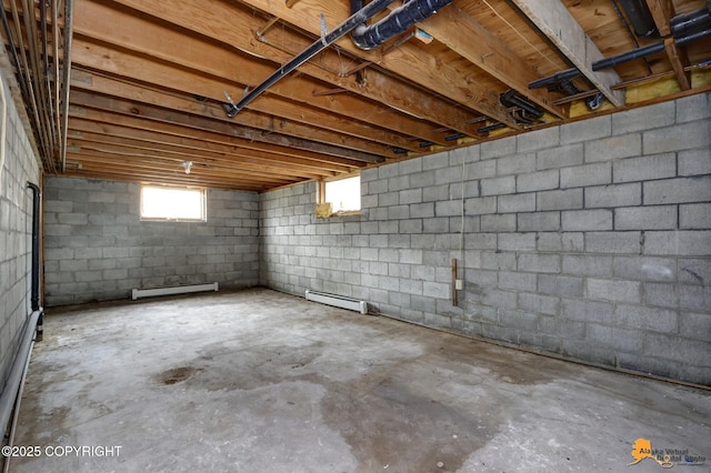 below grade area featuring a baseboard heating unit and a baseboard radiator