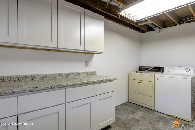 laundry area featuring washing machine and dryer and cabinet space