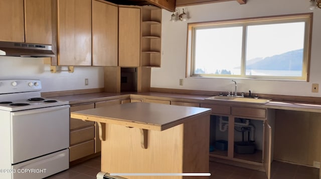 kitchen with a breakfast bar, a kitchen island, sink, dark tile flooring, and white range with electric cooktop