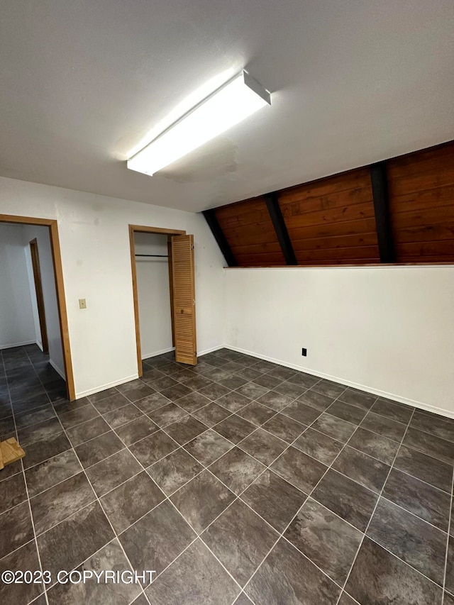 basement with dark tile flooring