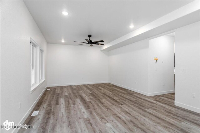 unfurnished room with a ceiling fan, wood finished floors, visible vents, baseboards, and recessed lighting