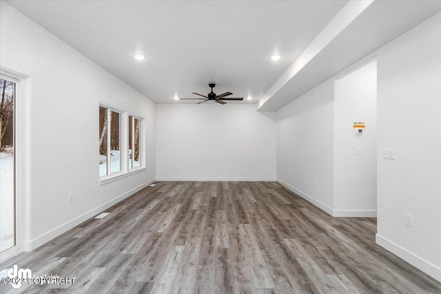 unfurnished room with ceiling fan and hardwood / wood-style flooring