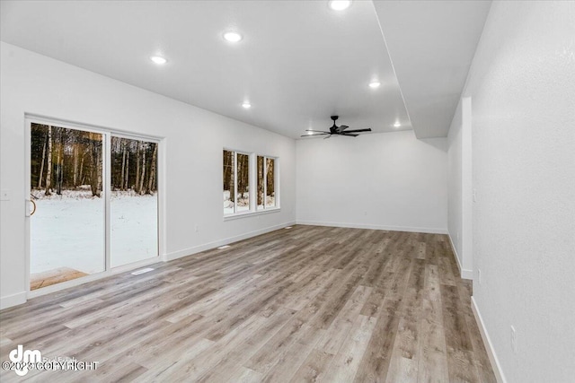 unfurnished room featuring recessed lighting, a wealth of natural light, and light wood-style flooring