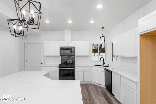 kitchen featuring appliances with stainless steel finishes, sink, white cabinets, and hardwood / wood-style flooring