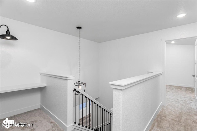 corridor featuring recessed lighting, baseboards, an upstairs landing, and carpet floors