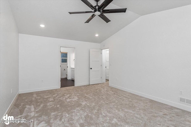 unfurnished bedroom featuring carpet, ceiling fan, vaulted ceiling, and connected bathroom