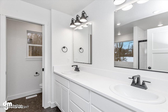 bathroom with double vanity, tile flooring, and toilet