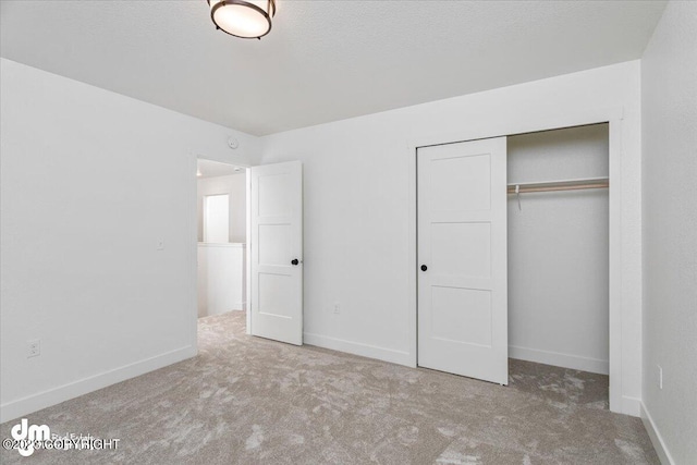 unfurnished bedroom featuring carpet flooring and a closet