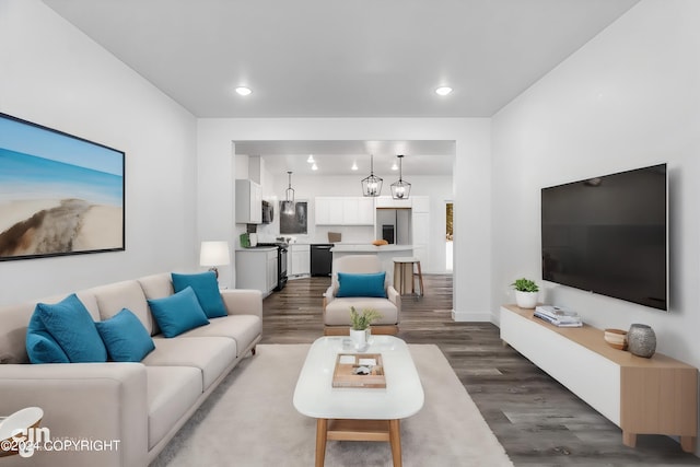 living area with recessed lighting, baseboards, and wood finished floors