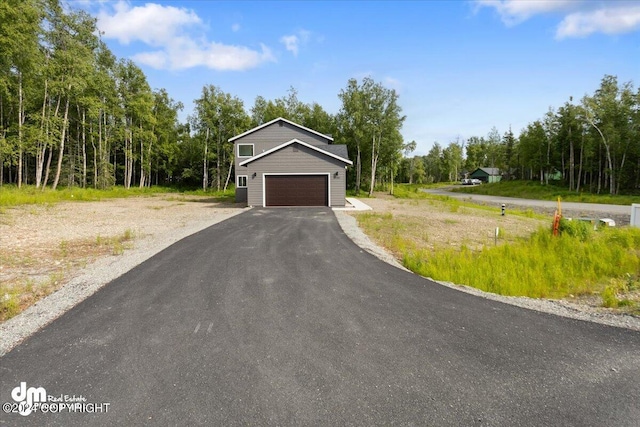 view of front of property featuring aphalt driveway and a garage