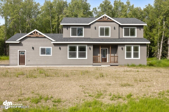 view of front facade featuring a porch and a shingled roof