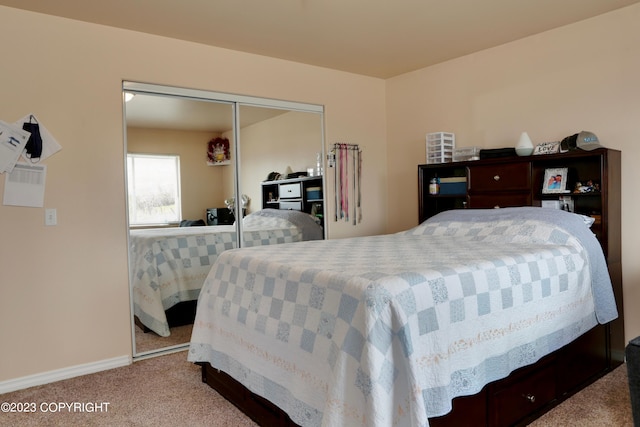 bedroom featuring a closet and light carpet