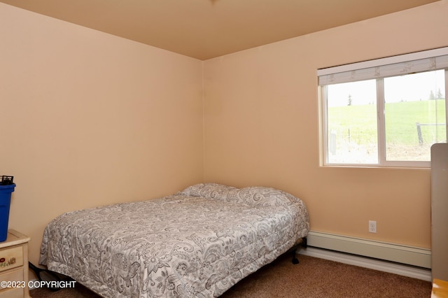 bedroom with baseboard heating and dark colored carpet