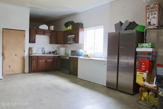 kitchen with appliances with stainless steel finishes, sink, and dark brown cabinetry