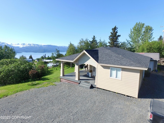 view of front of house featuring a front yard and a water and mountain view