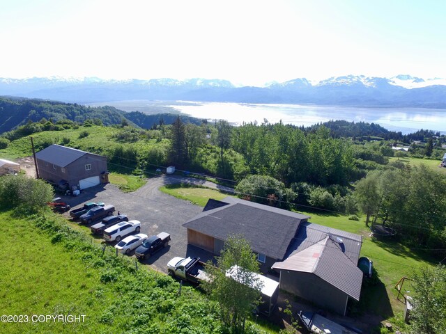 drone / aerial view featuring a water and mountain view