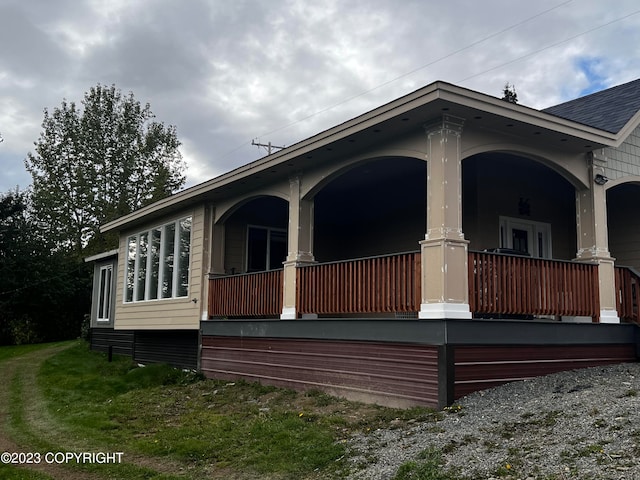 view of side of property with covered porch