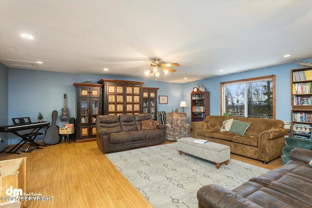 living area with recessed lighting, ceiling fan, and wood finished floors