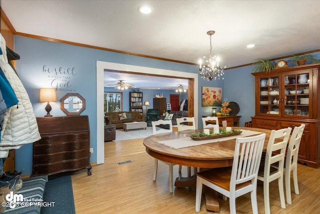 dining area featuring visible vents, ornamental molding, recessed lighting, ceiling fan with notable chandelier, and light wood-style floors