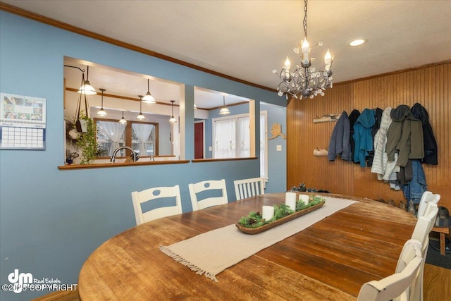 dining area featuring a notable chandelier and ornamental molding