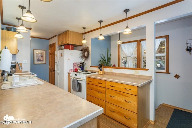 kitchen with crown molding, baseboards, light countertops, white appliances, and a sink