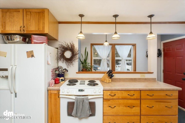 kitchen with white appliances, light countertops, and pendant lighting