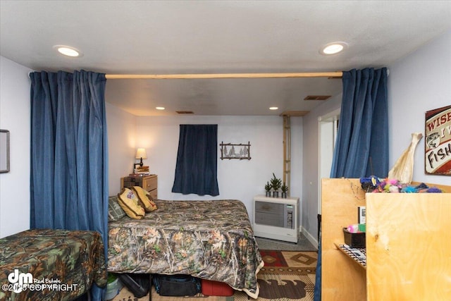 bedroom featuring recessed lighting, visible vents, and heating unit