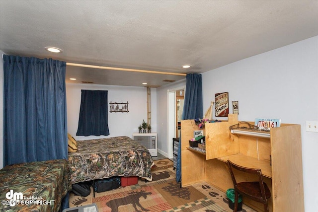 bedroom with recessed lighting and a textured ceiling