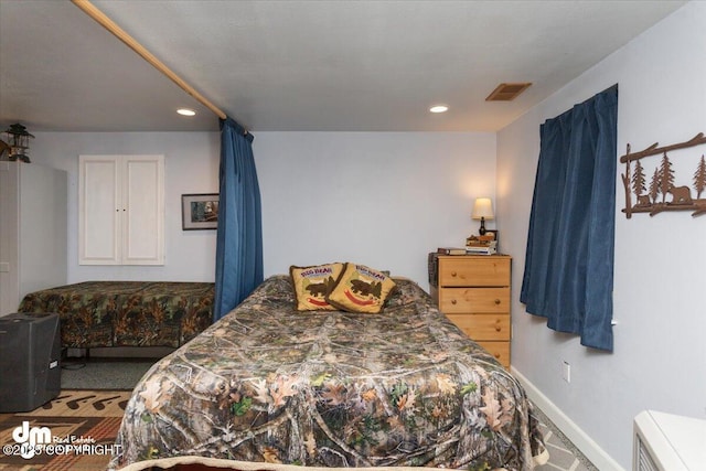 carpeted bedroom with recessed lighting, visible vents, and baseboards