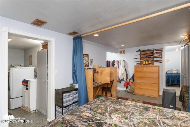 bedroom featuring recessed lighting, washing machine and dryer, and visible vents