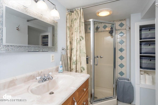 full bath with vanity and a shower stall