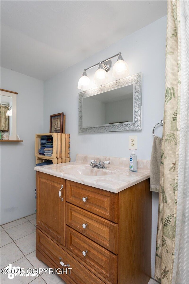 full bathroom featuring tile patterned floors and vanity